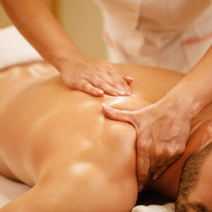 A person receiving a deep tissue massage, with focused pressure on muscles for therapeutic relief.